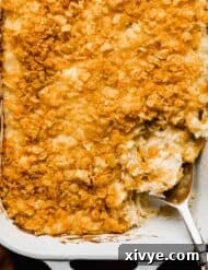 Golden Comfort Bake 10 Overhead photo of Funeral Potatoes baked in a white rectangular dish.