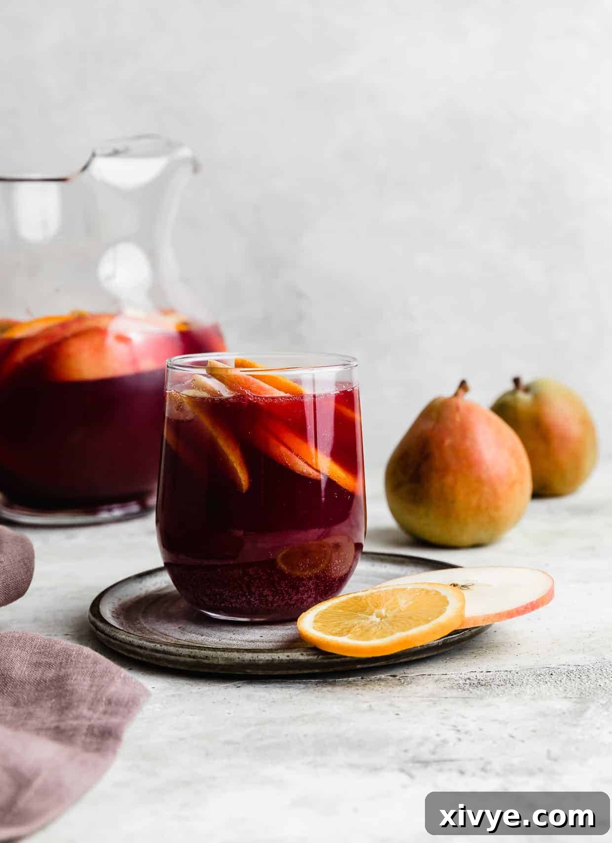 Virgin Sangria 2 A glass of Non-Alcoholic Sangria against a gray background.