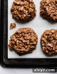 A delicious chocolate peanut butter oatmeal no bake cookie on a white parchment paper.