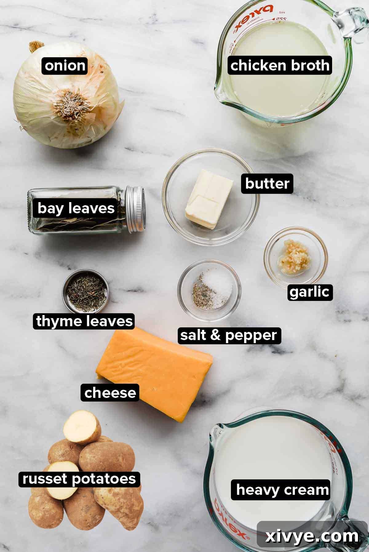 Ultimate Gluten Free Scalloped Potatoes 3 Scalloped potato recipe ingredients portioned into glass bowls on a white and gray marble background.