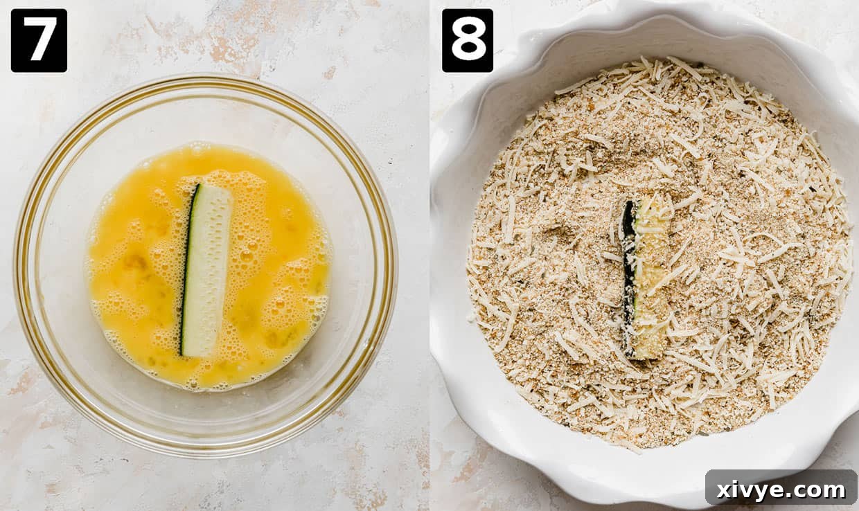 A zucchini ferie in a bowl of mixed egg, then transferred to a plate with seasonings and bread crumbs. 