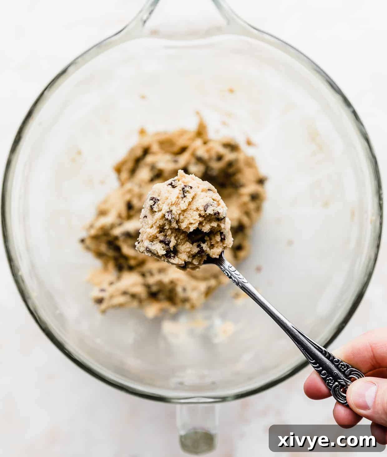 Ben and Jerrys Irresistible Cookie Dough Bites 11 A spoon holding up a large scoop of edible homemade Ben and Jerry's Cookie Dough.