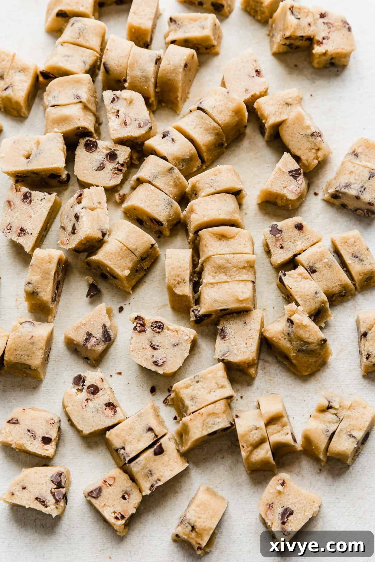 Ben and Jerrys Irresistible Cookie Dough Bites 13 Chunks of homemade Ben and Jerry's Cookie Dough Bites on a light gray cutting board.