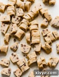 Ben and Jerrys Irresistible Cookie Dough Bites 14 Chunks of homemade Ben and Jerry's Cookie Dough Bites on a light gray cutting board.