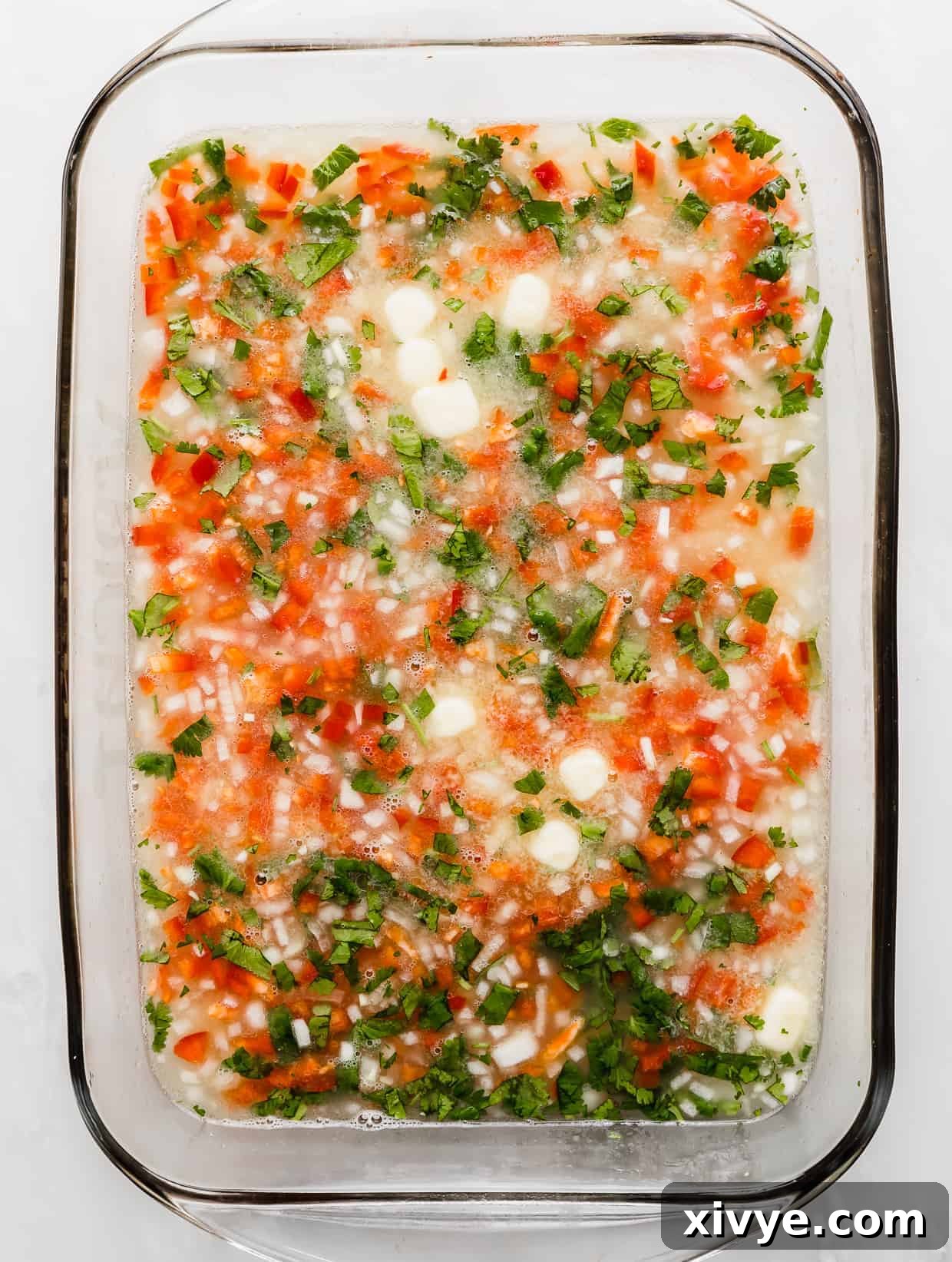 Sweet Bell Pepper Pilaf 4 A baking dish full of ingredients used to make Sweet Pepper Rice.