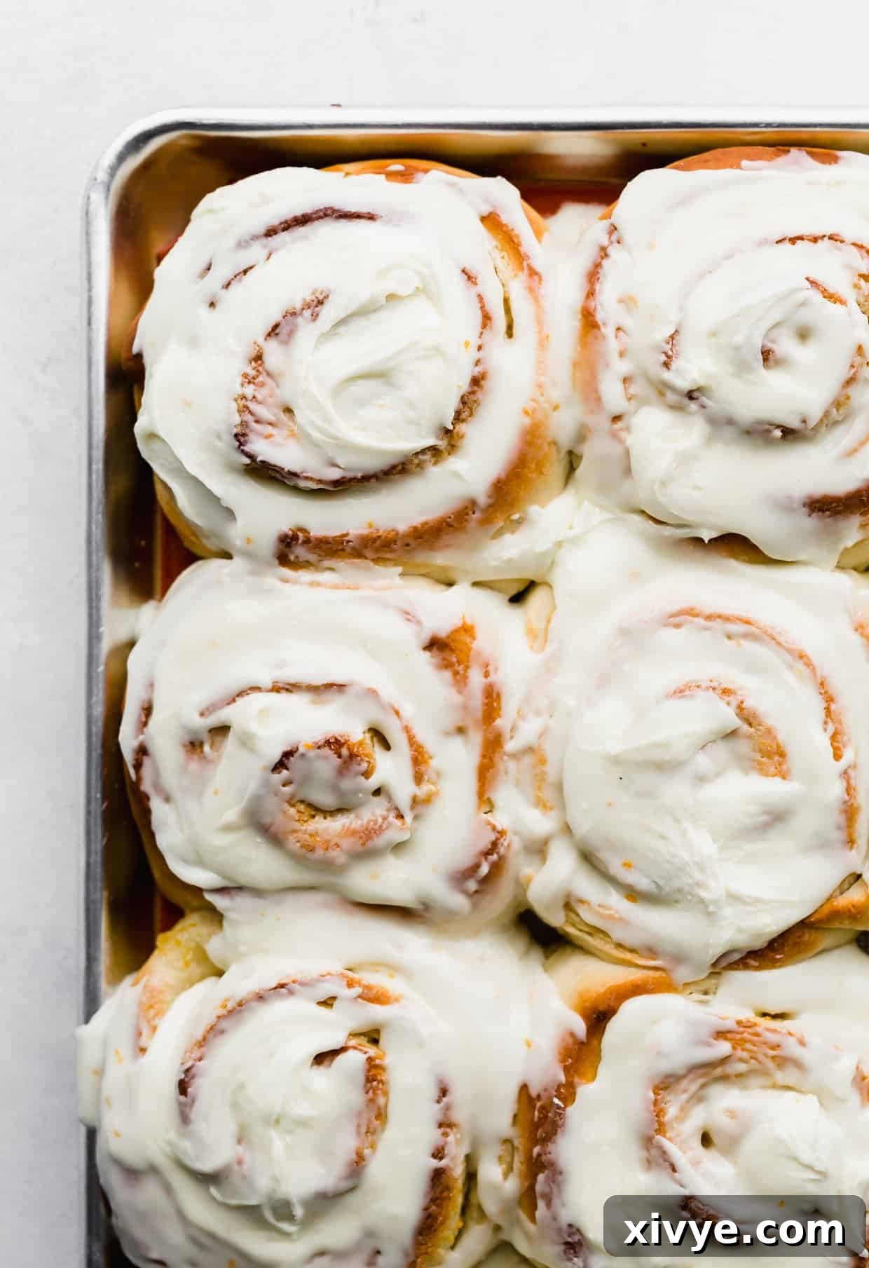 Frosted Orange Rolls on a baking sheet.