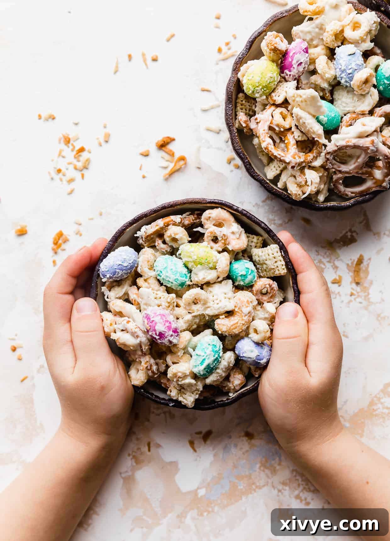 Easter Bunny Crunch Mix 7 Small hands grabbing a bowl of bunny bait, highlighting its appeal to children.