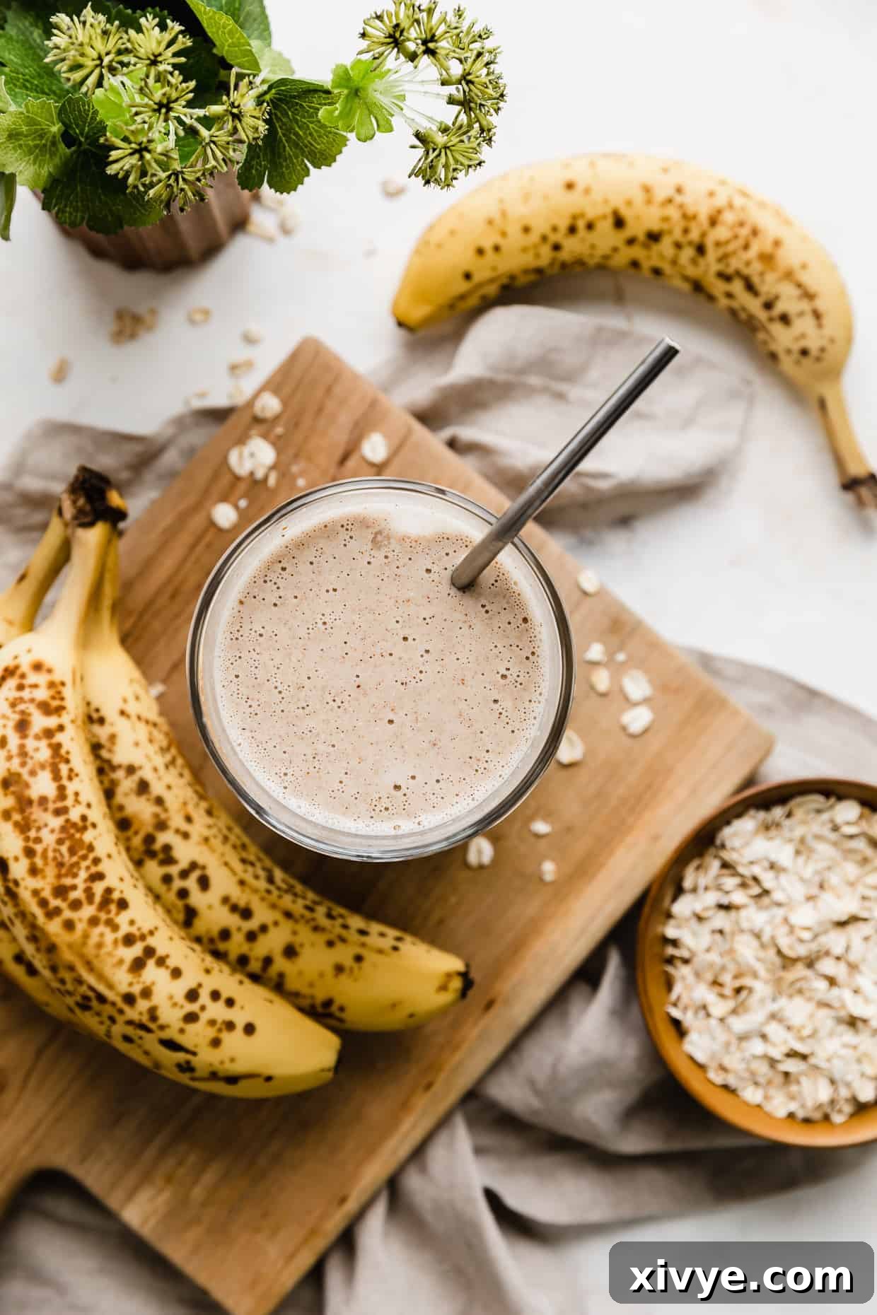 Mama's Milk Smoothie 6 Overhead photo of a Lactation Smoothie on a wooden board with bananas around.