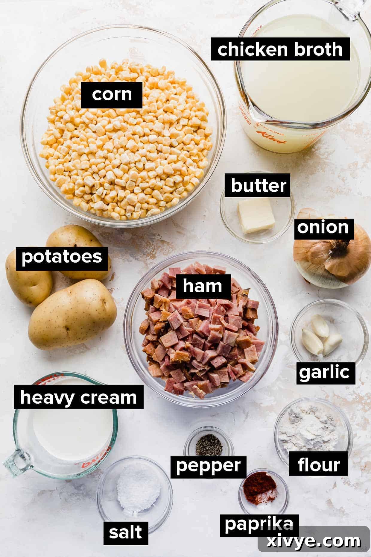 Creamy Ham and Sweet Corn Chowder 3 Ingredients used to make ham and corn chowder on a white background.