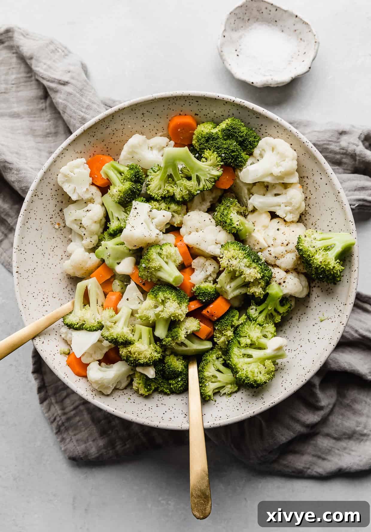 Buttered Vegetables featuring broccoli, cauliflower, and carrots in a serving bowl.