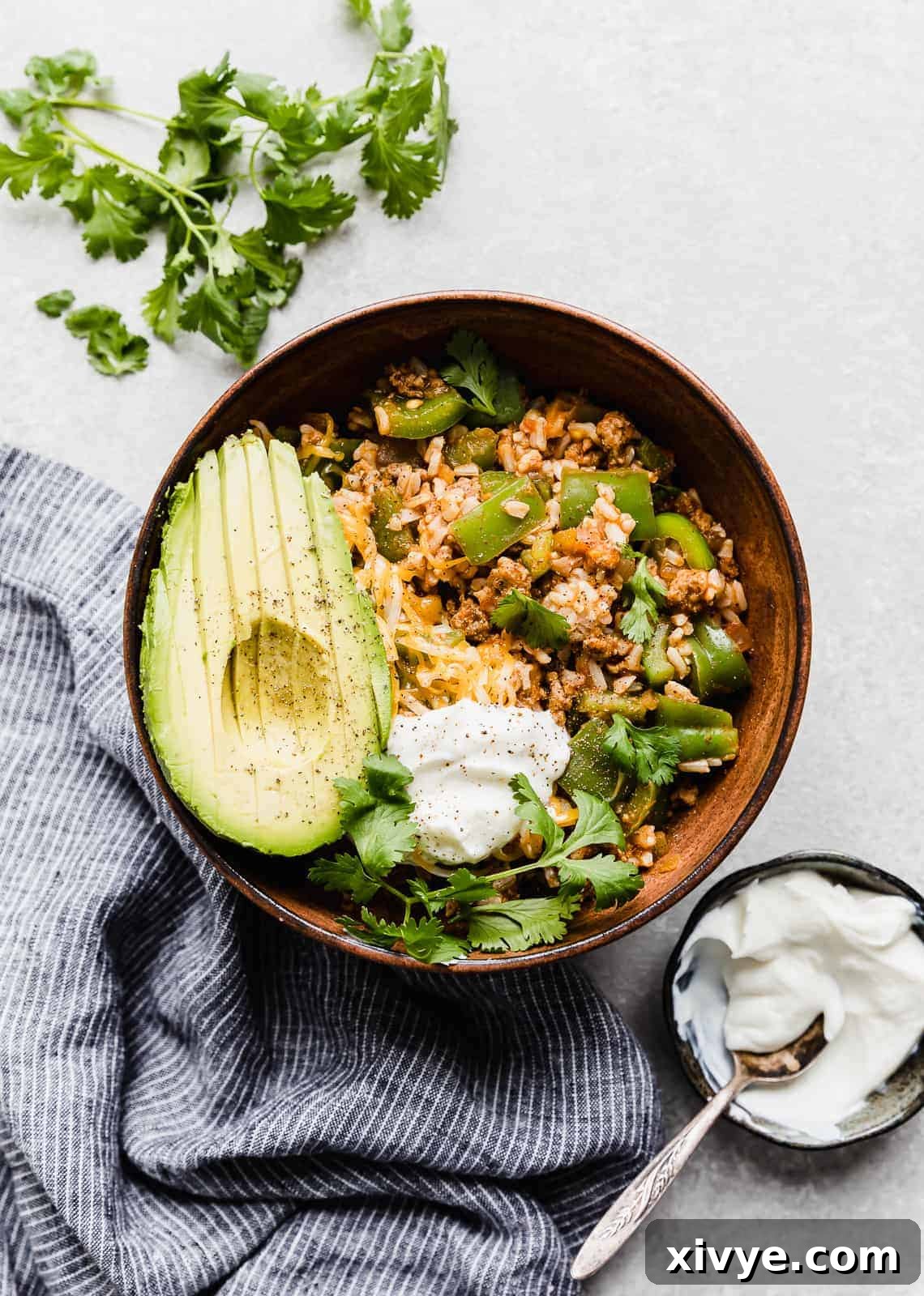 Unstuffed Pepper Casserole 2 A photo of Deconstructed Stuffed Peppers in a brown bowl against a white background.