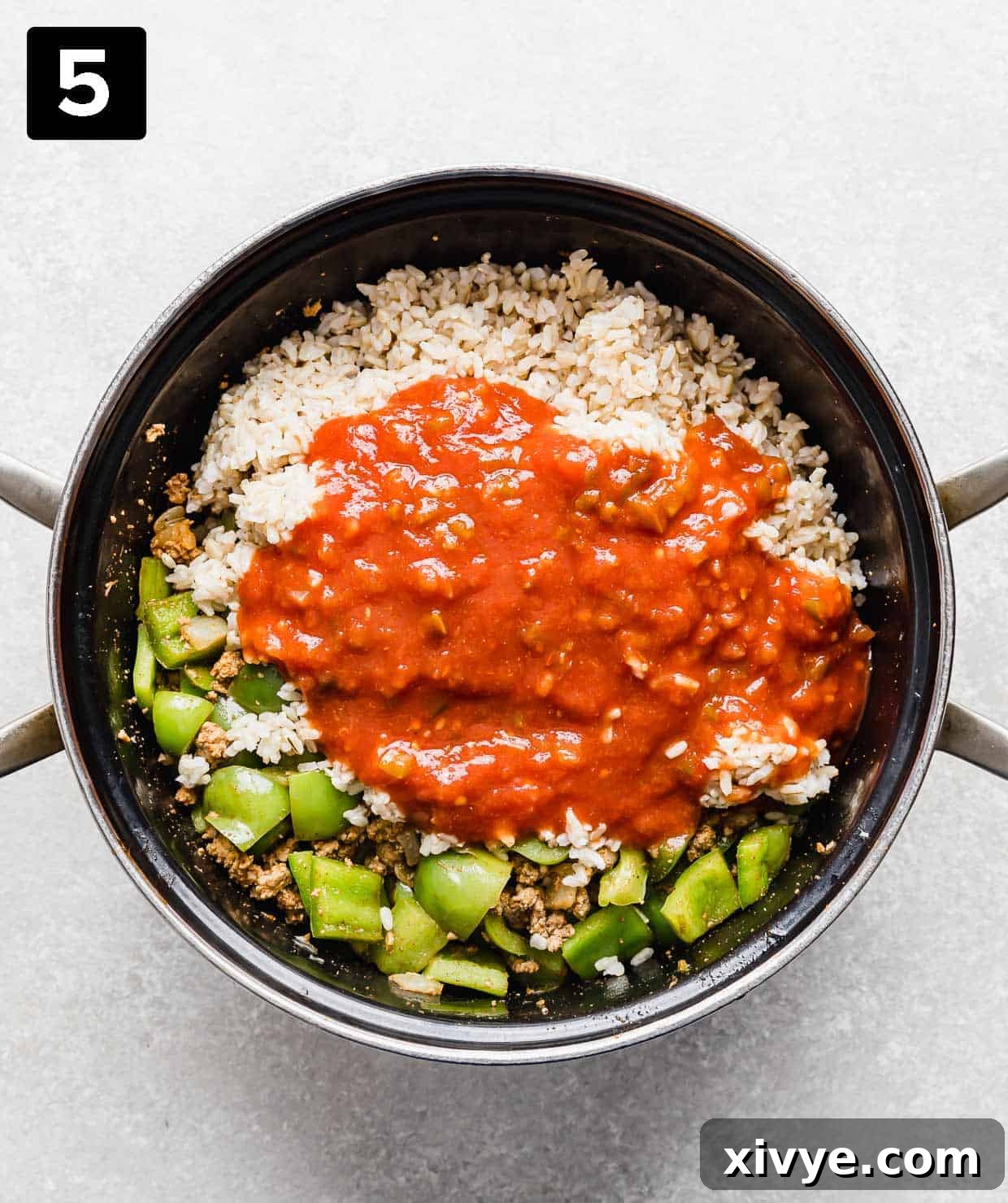 Unstuffed Pepper Casserole 5 A large pot with rice, chopped green peppers, and salsa in it.