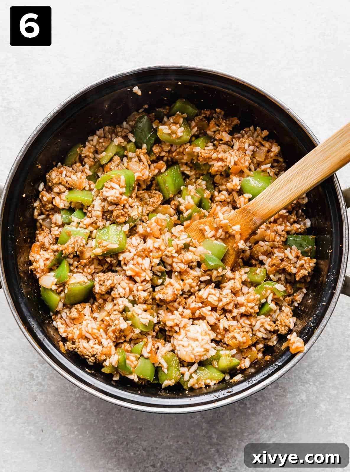 Unstuffed Pepper Casserole 6 Deconstructed Stuffed Peppers in a large black pot against a light gray background.