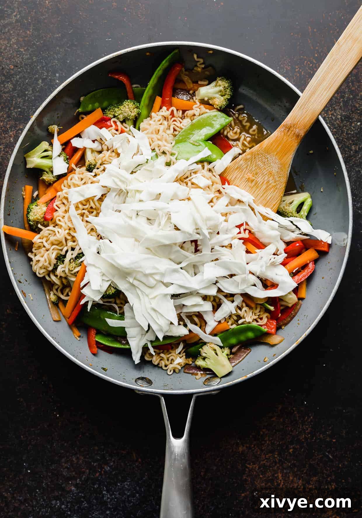 Sliced cabbage overtop Ramen with Vegetables.