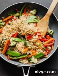 Cooked ramen with vegetables in a gray skillet.