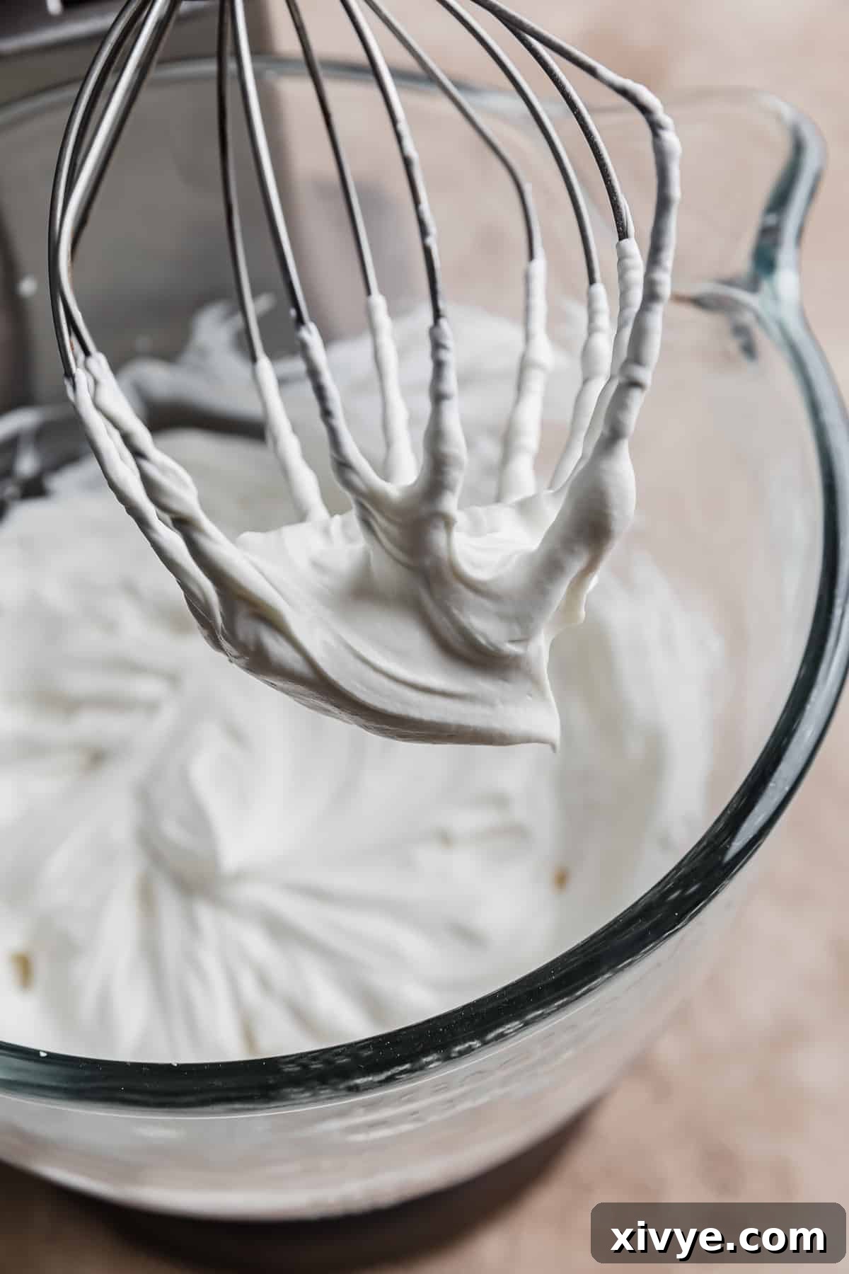 Tangy Greek Yogurt Whip 7 A whisk with perfectly blended Greek Yogurt Whipped Cream, showing its final smooth consistency.