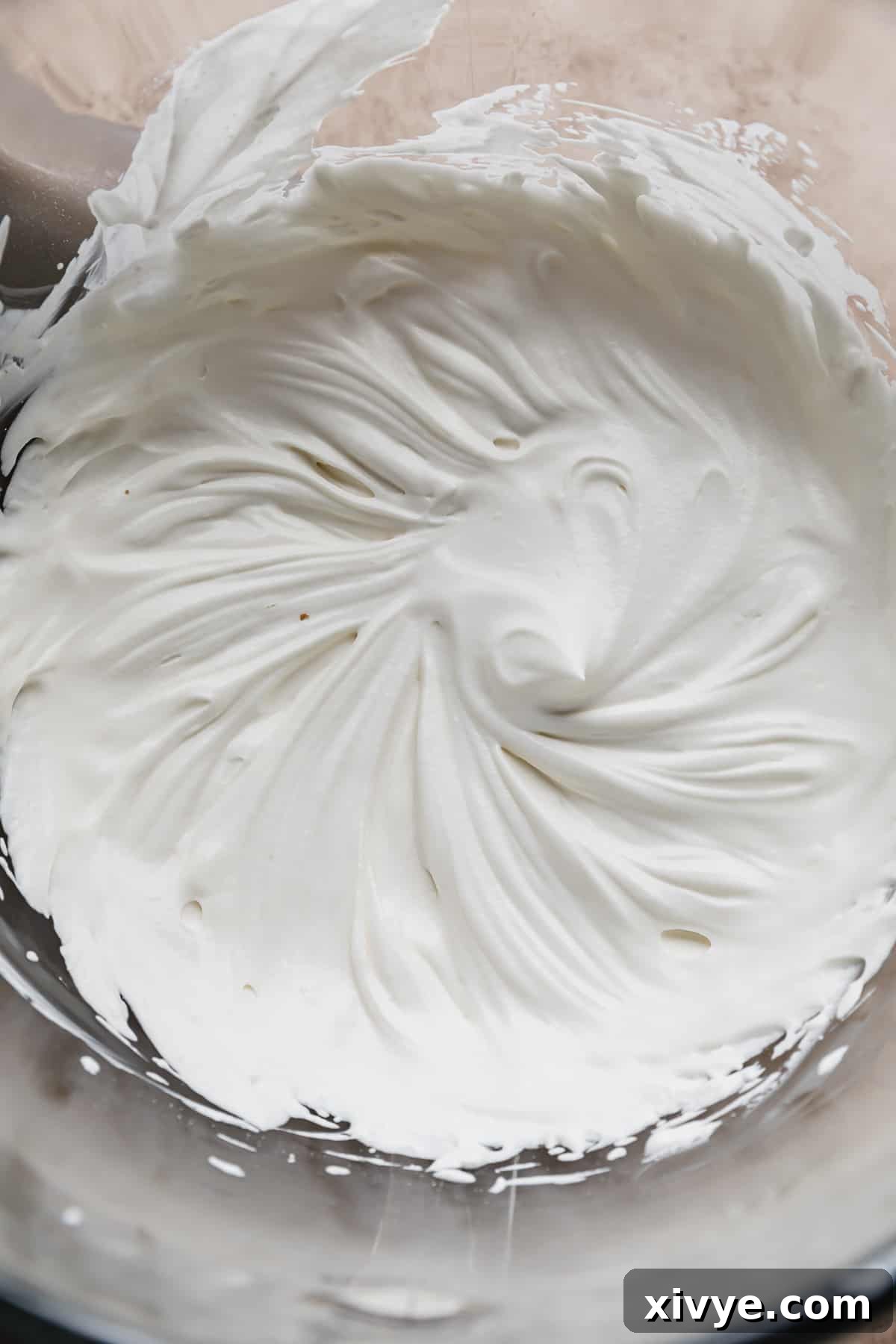 Tangy Greek Yogurt Whip 8 A beautiful bowl filled with fluffy, white Greek Yogurt Whipped Cream, ready to be served.