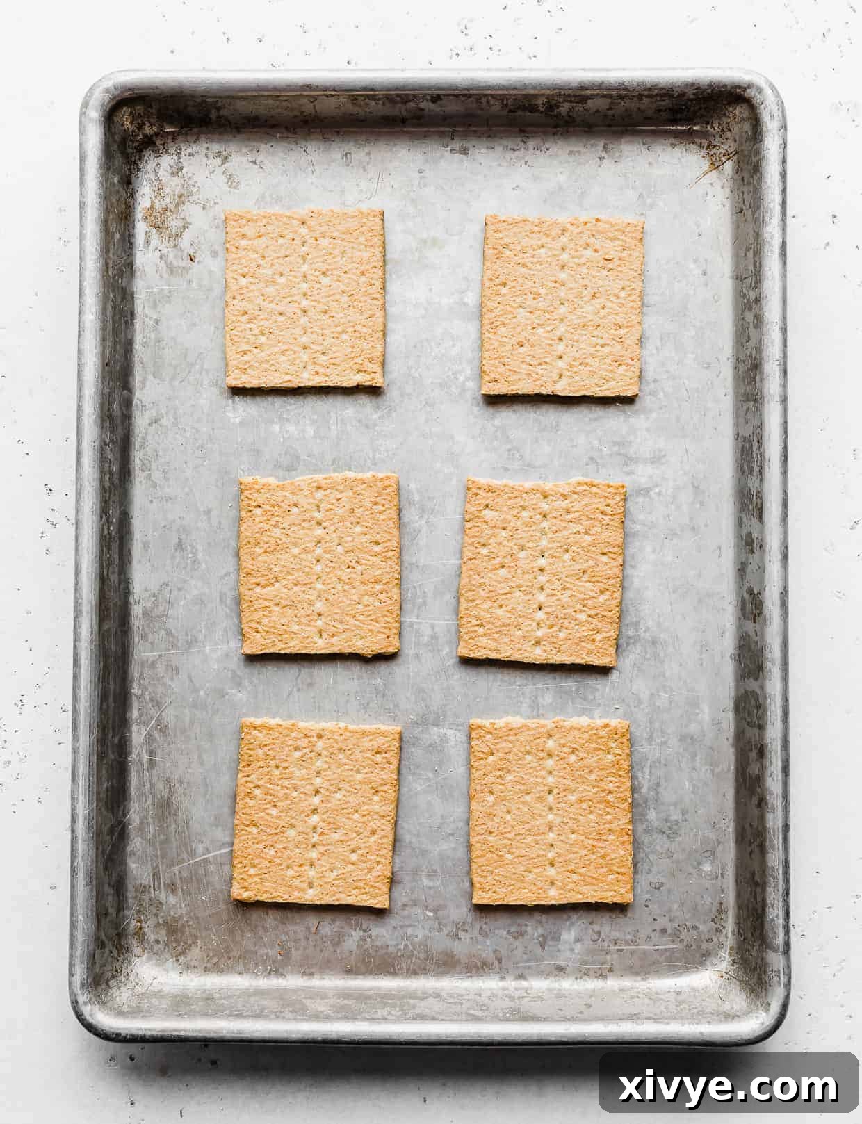 6 graham cracker squares on a baking sheet.