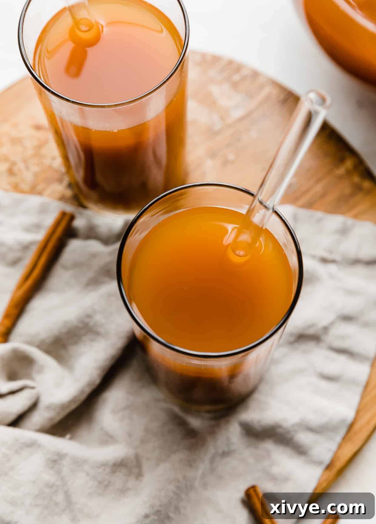 Overhead photo of Pumpkin Juice in a glass cup with a glass straw in the drink.