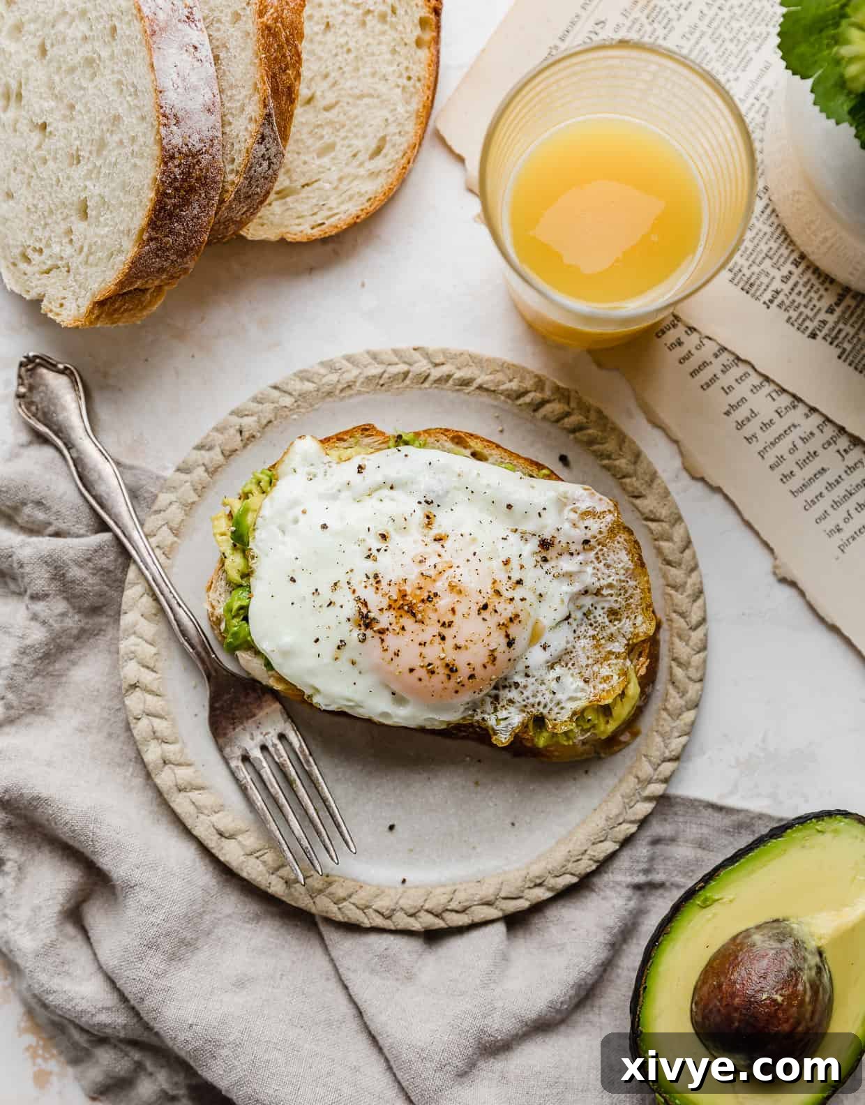 Creamy Avocado Egg Toast 8 A slice of bread with smashed avocado and a perfectly cooked egg on it, ready to eat.
