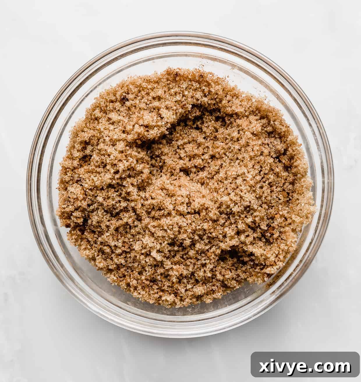 Irresistible Mini Cinnies 11 The mixed brown sugar and cinnamon filling in a glass bowl, showing its crumbly texture.