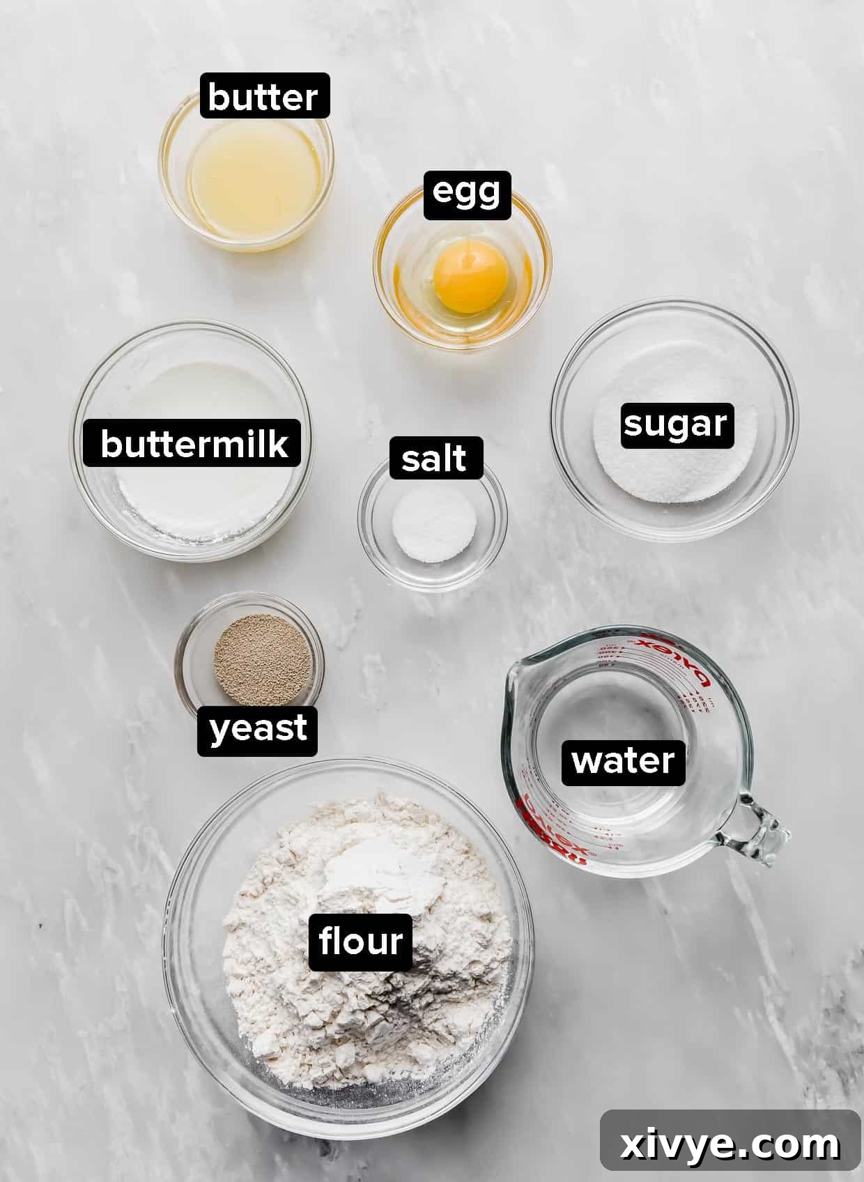 Irresistible Mini Cinnies 3 All the fresh and dry ingredients laid out on a white surface, ready to make homemade mini cinnamon rolls.