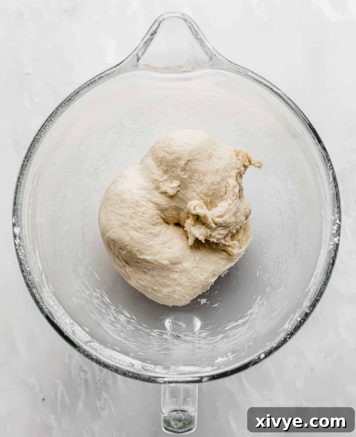 Irresistible Mini Cinnies 8 Soft cinnamon roll dough resting in a glass bowl, just before its short proofing.