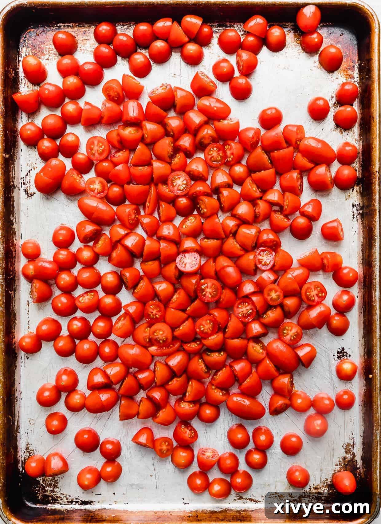 Grape tomatoes on a baking sheet.