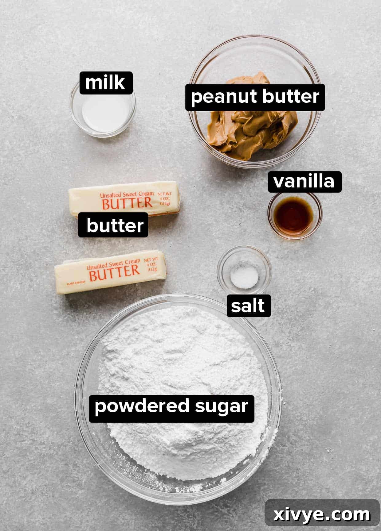 Ingredients used to make peanut butter frosting on a gray background. 