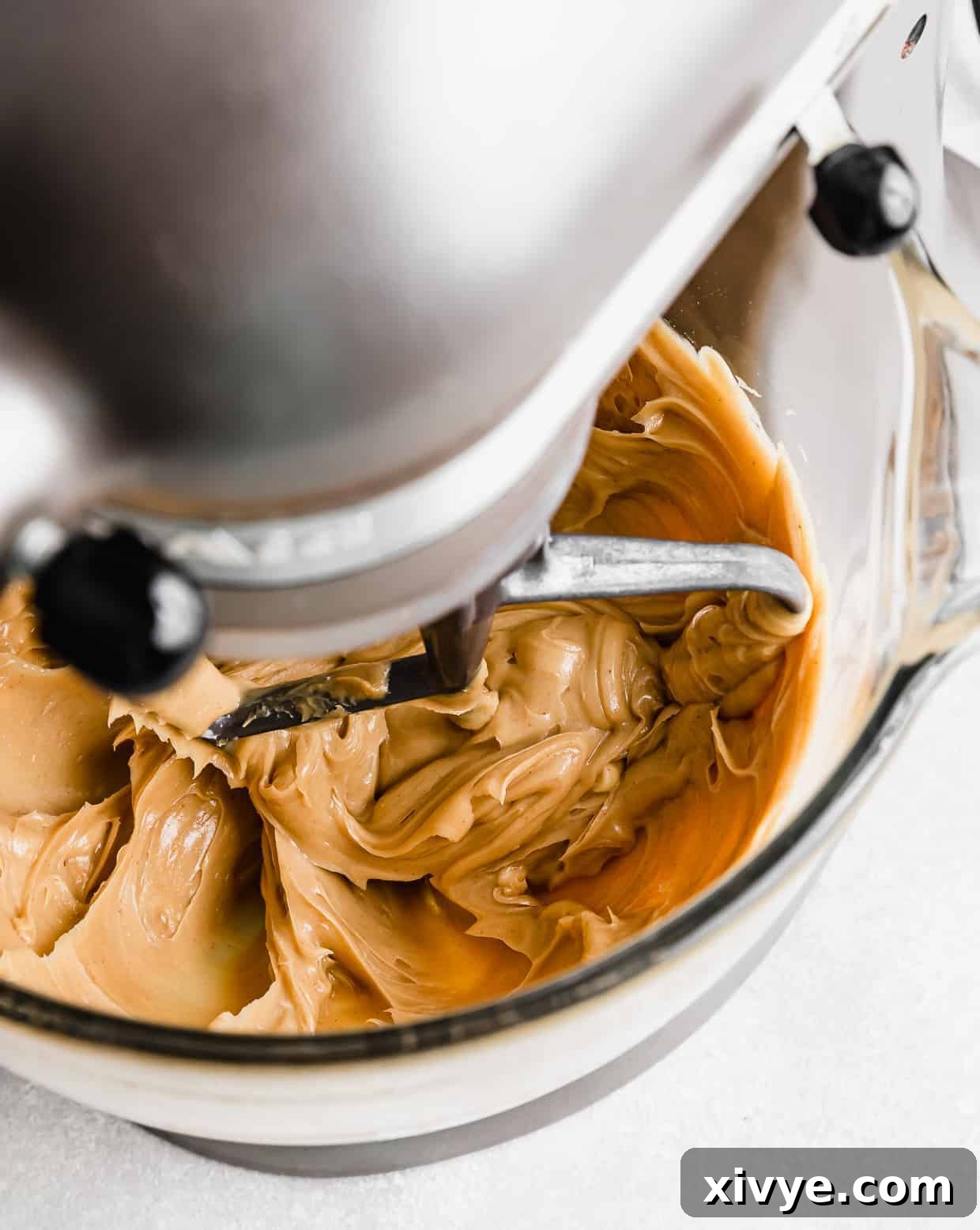 Creamy Peanut Butter Frosting being mixed in a stand mixer.