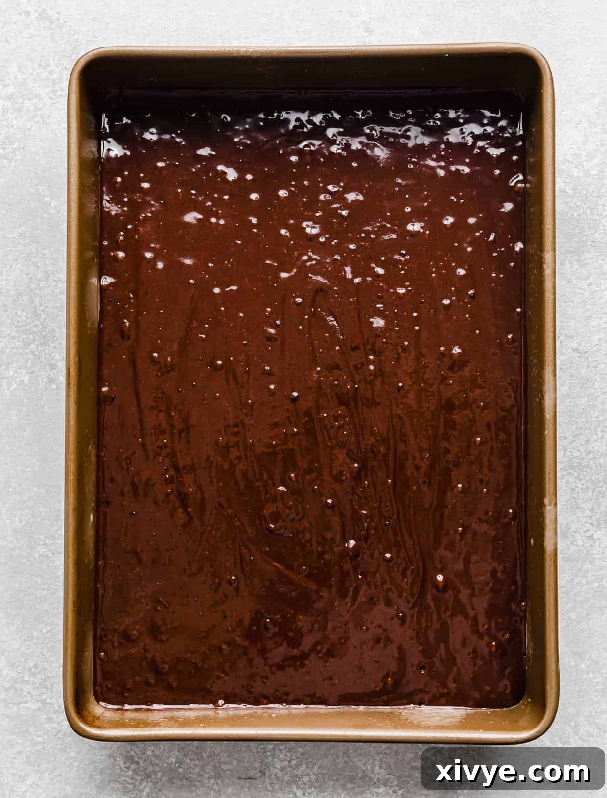 A 13x9 inch pan full of chocolate cake batter.