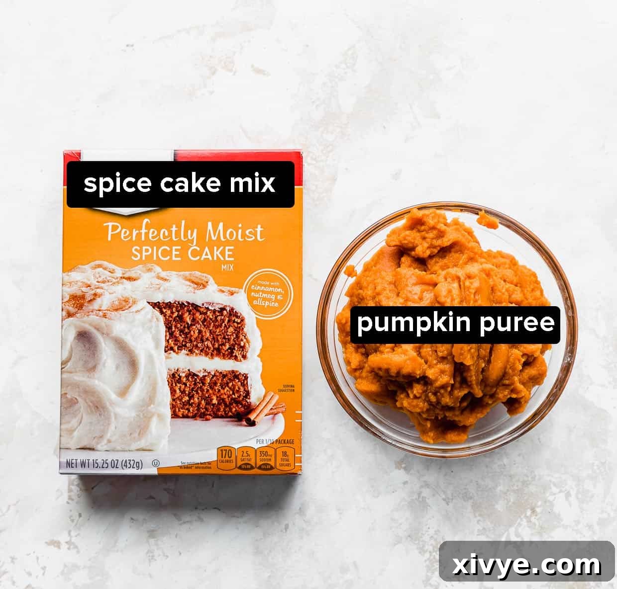 A box of spice cake mix and a bowl of pumpkin puree on a cream textured background, ready for baking.
