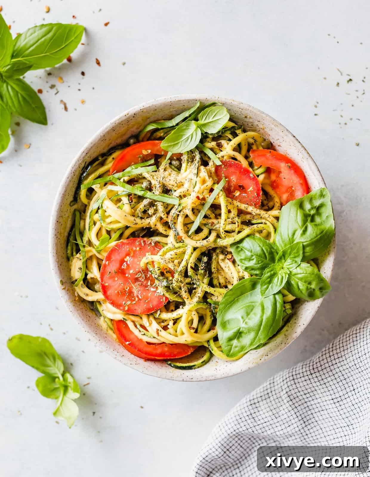 Sun-Kissed Zucchini Pasta 2 5-Minute Cheesy Zucchetti Bowl is the perfect zucchini noodles recipe! It's a fun and delicious way to eat your veggies! This delicious gluten free bowl is low carb too!