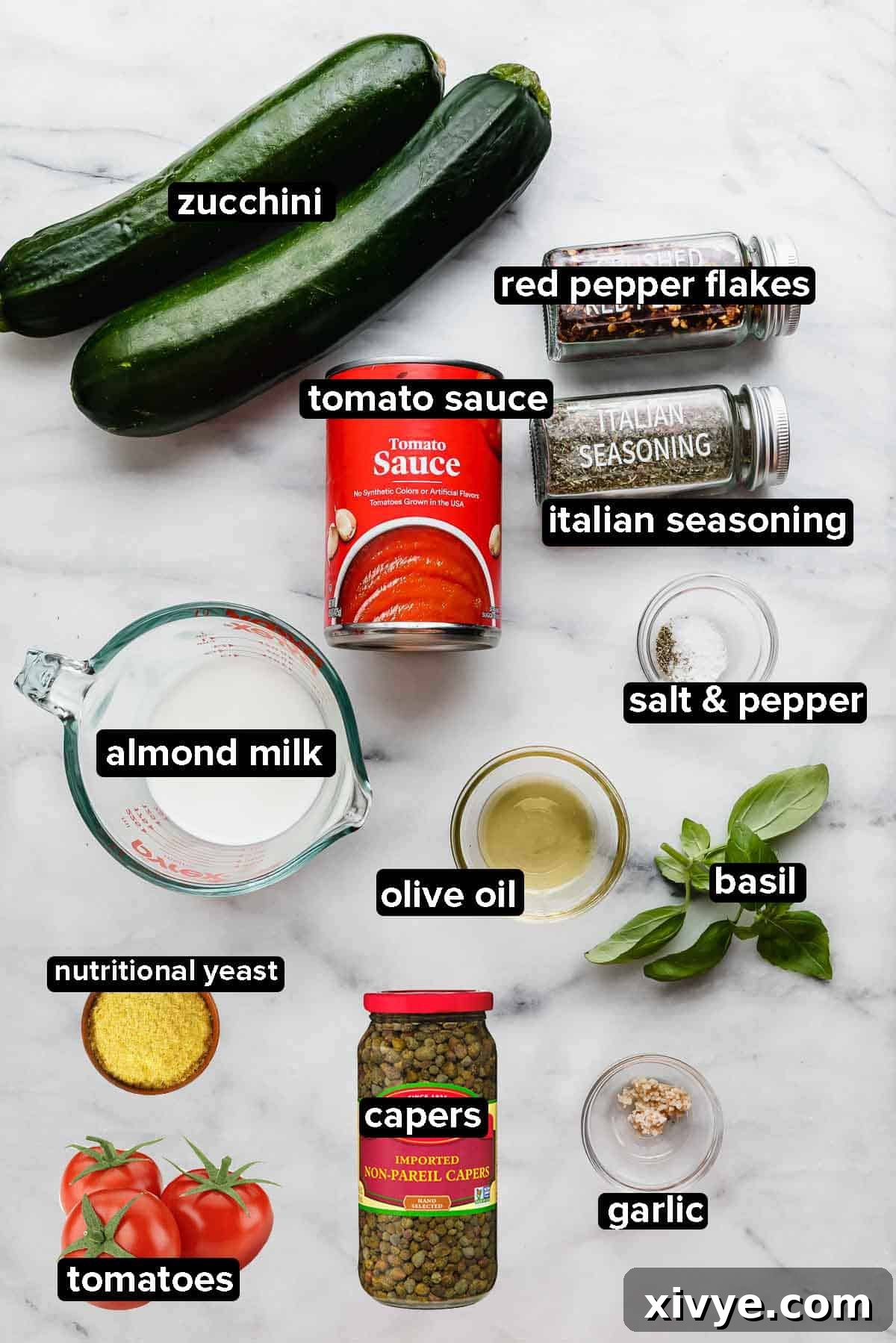 Sun-Kissed Zucchini Pasta 3 Zucchetti Pasta ingredients on a white marble background.