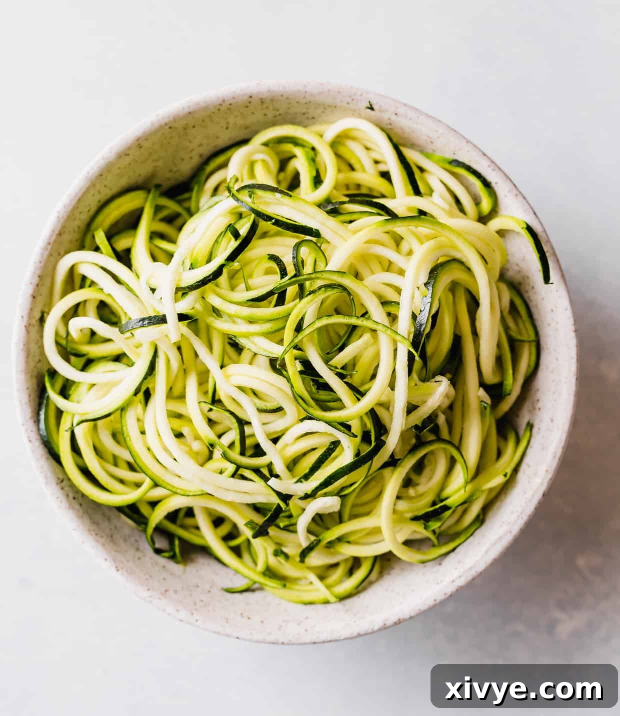 Sun-Kissed Zucchini Pasta 4 A pile of zucchini noodles in a bowl.