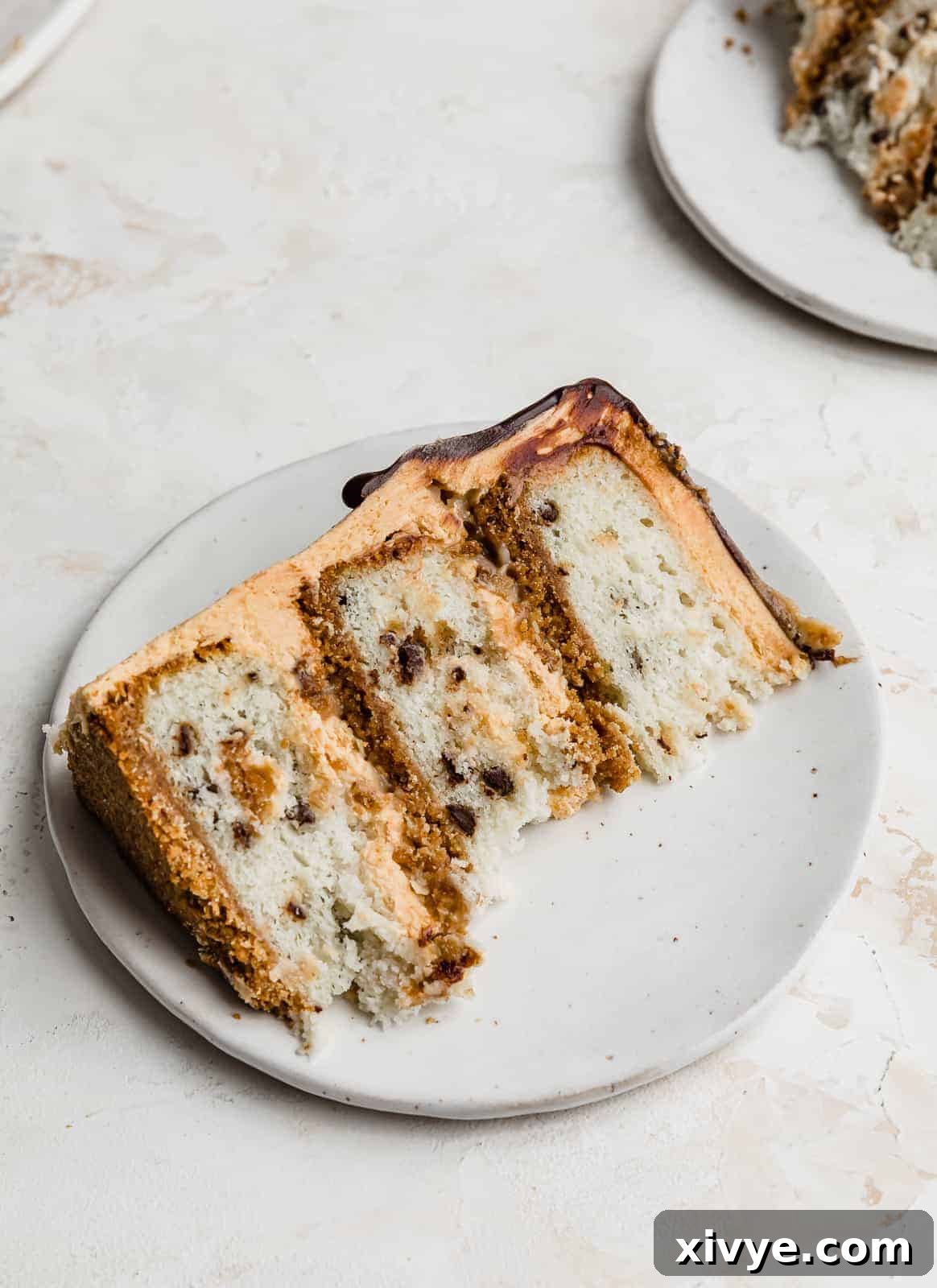A perfectly portioned slice of 7 Layer Bar Cake, showcasing its vibrant layers and inviting texture, presented on a simple white plate.