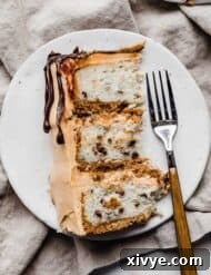 A slice of 7 Layer Bar Cake on a white plate, showing the distinct layers.