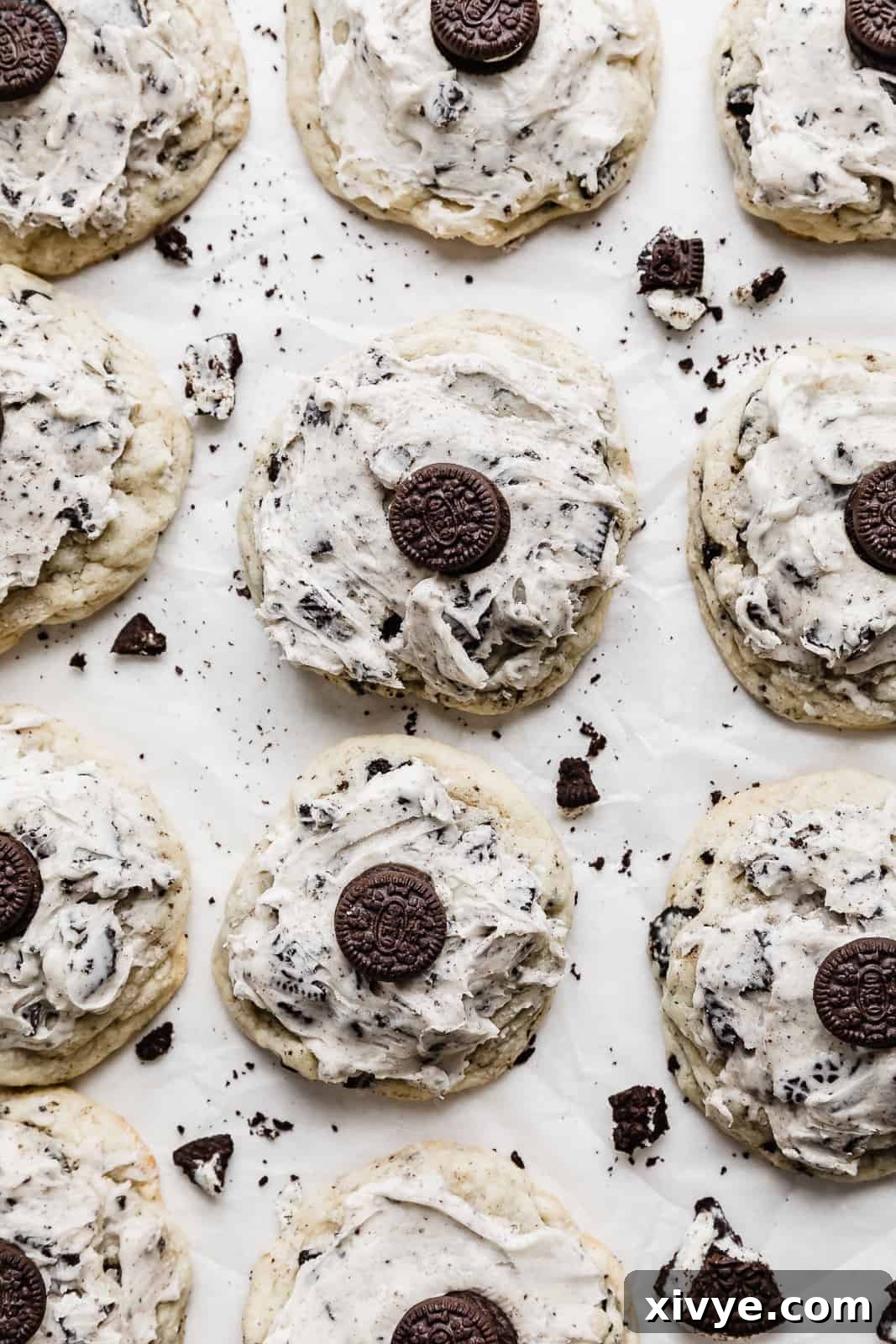 Overhead photo of freshly baked cookies and cream cookies, beautifully topped with creamy frosting and a mini Oreo.