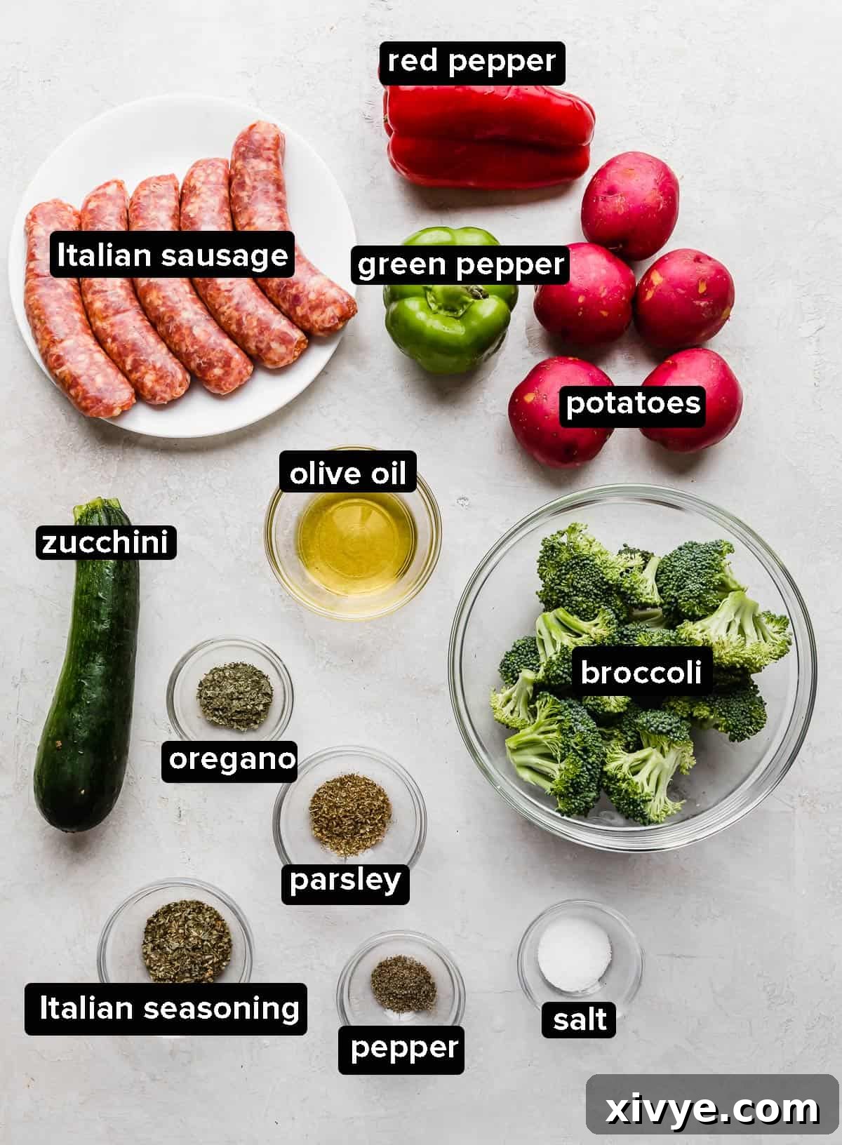 One-Pan Italian Sausage and Roasted Vegetables 3 Sheet Pan Italian Sausage and Veggies ingredients on a gray background.