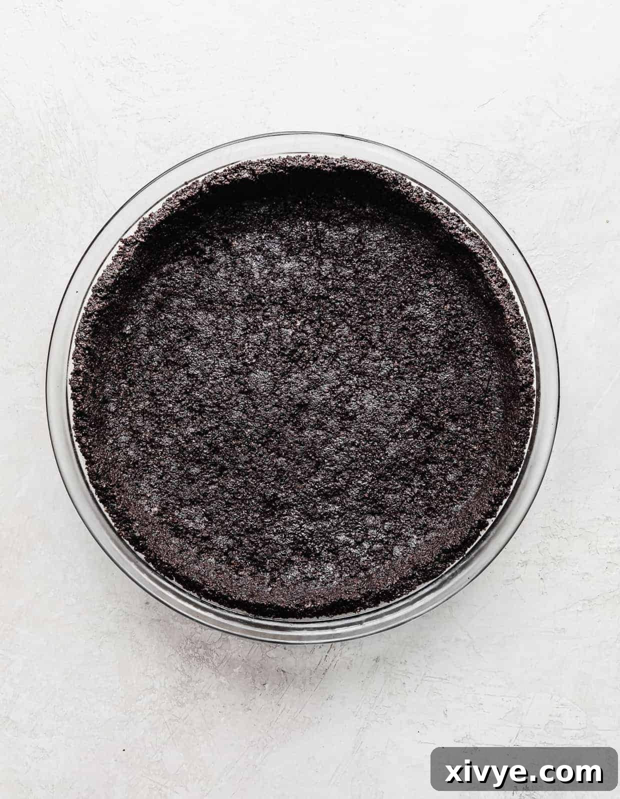 Irresistible Oreo Pie Crust 2 An Oreo Pie Crust on a light gray background.