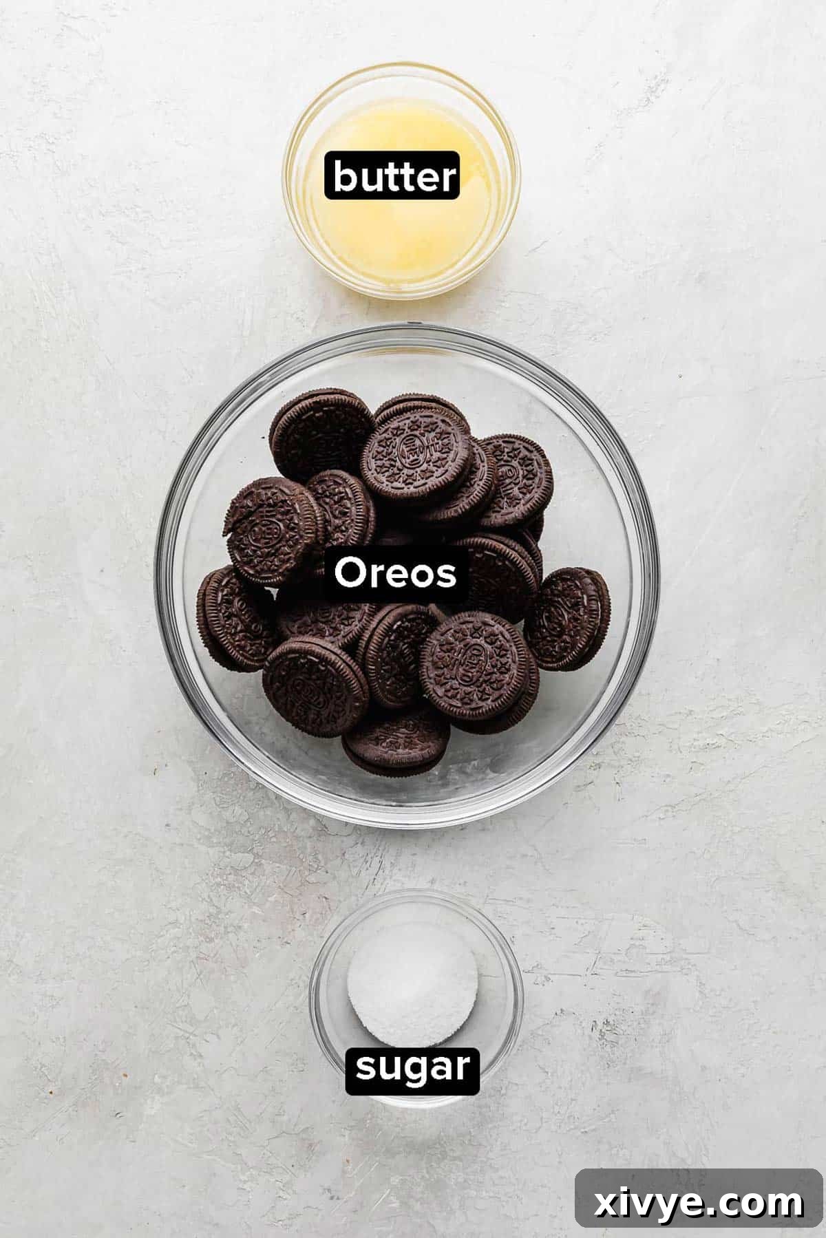 Irresistible Oreo Pie Crust 3 Oreo Pie Crust ingredients on a gray background.