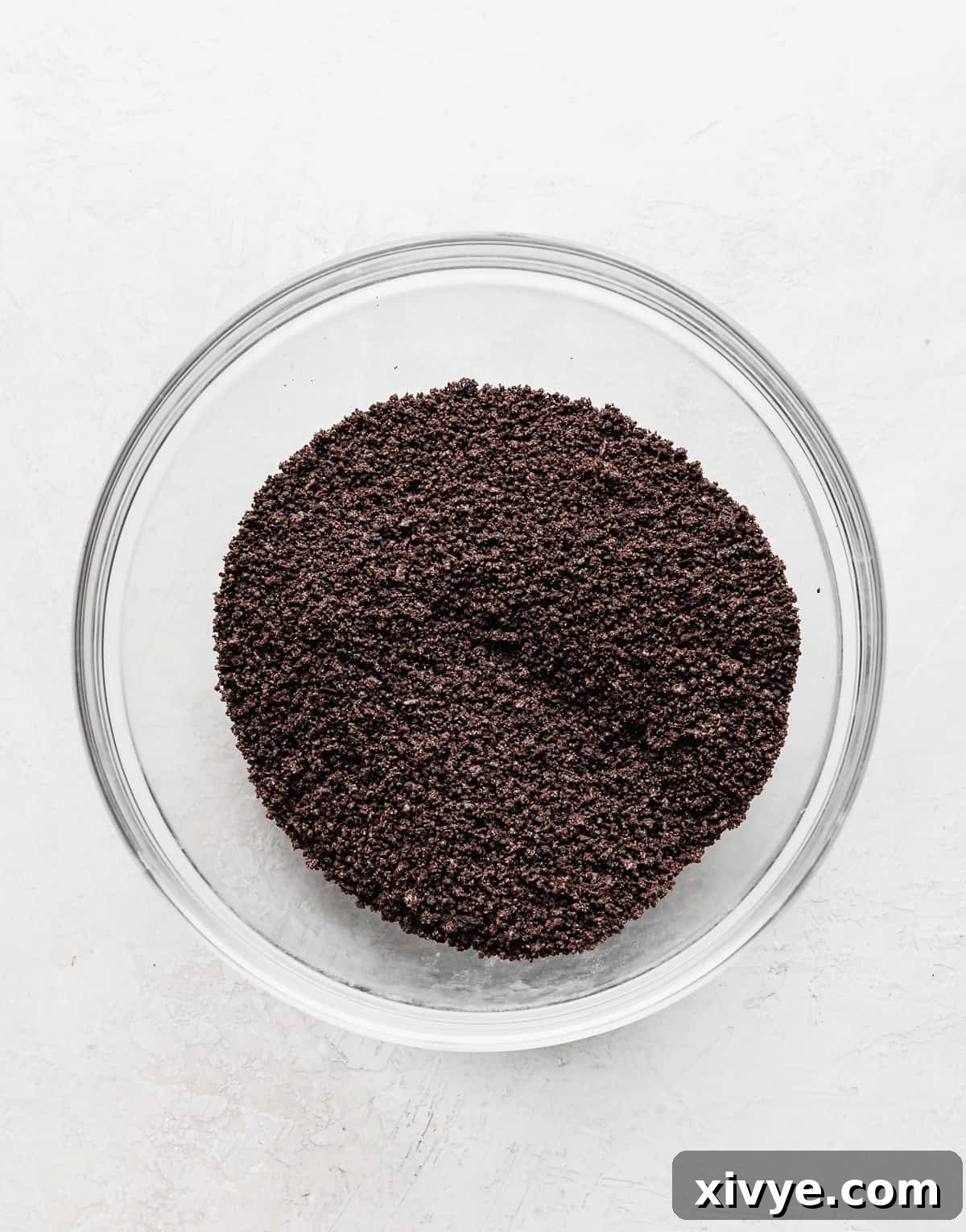 Irresistible Oreo Pie Crust 4 Crushed oreo crumbs in a glass bowl.