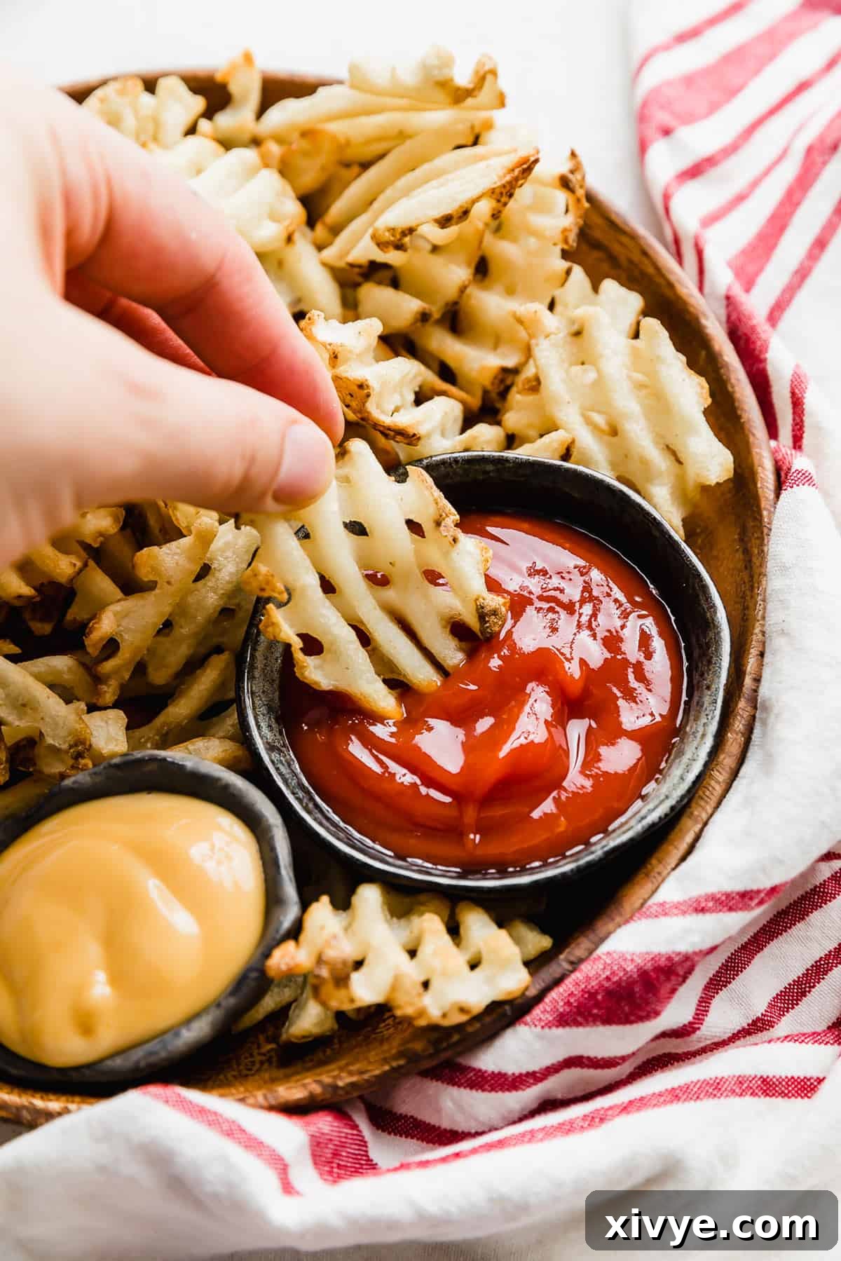 Crispy Waffle Fries from Your Air Fryer 8 A vibrant, close-up shot of perfectly air-fried waffle fries, golden brown and ready to eat.