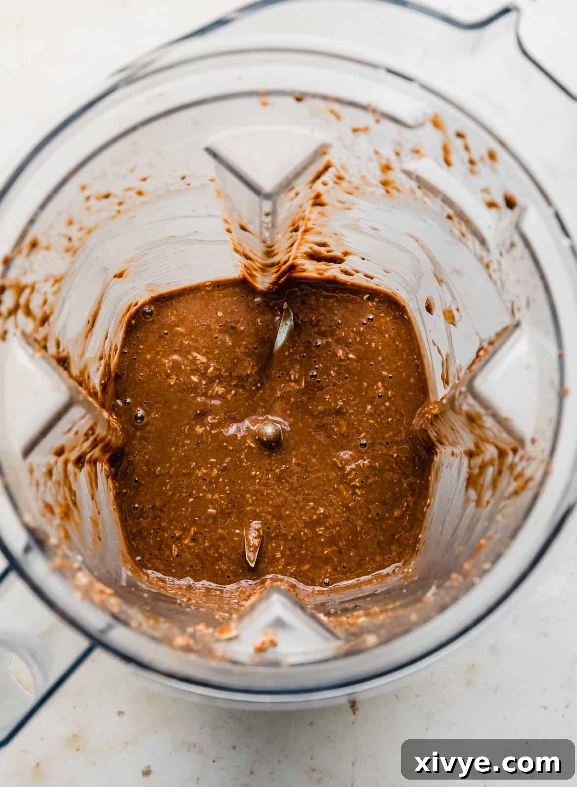 Blended Chocolate Baked Oats batter in a blender, showing a smooth, creamy texture.