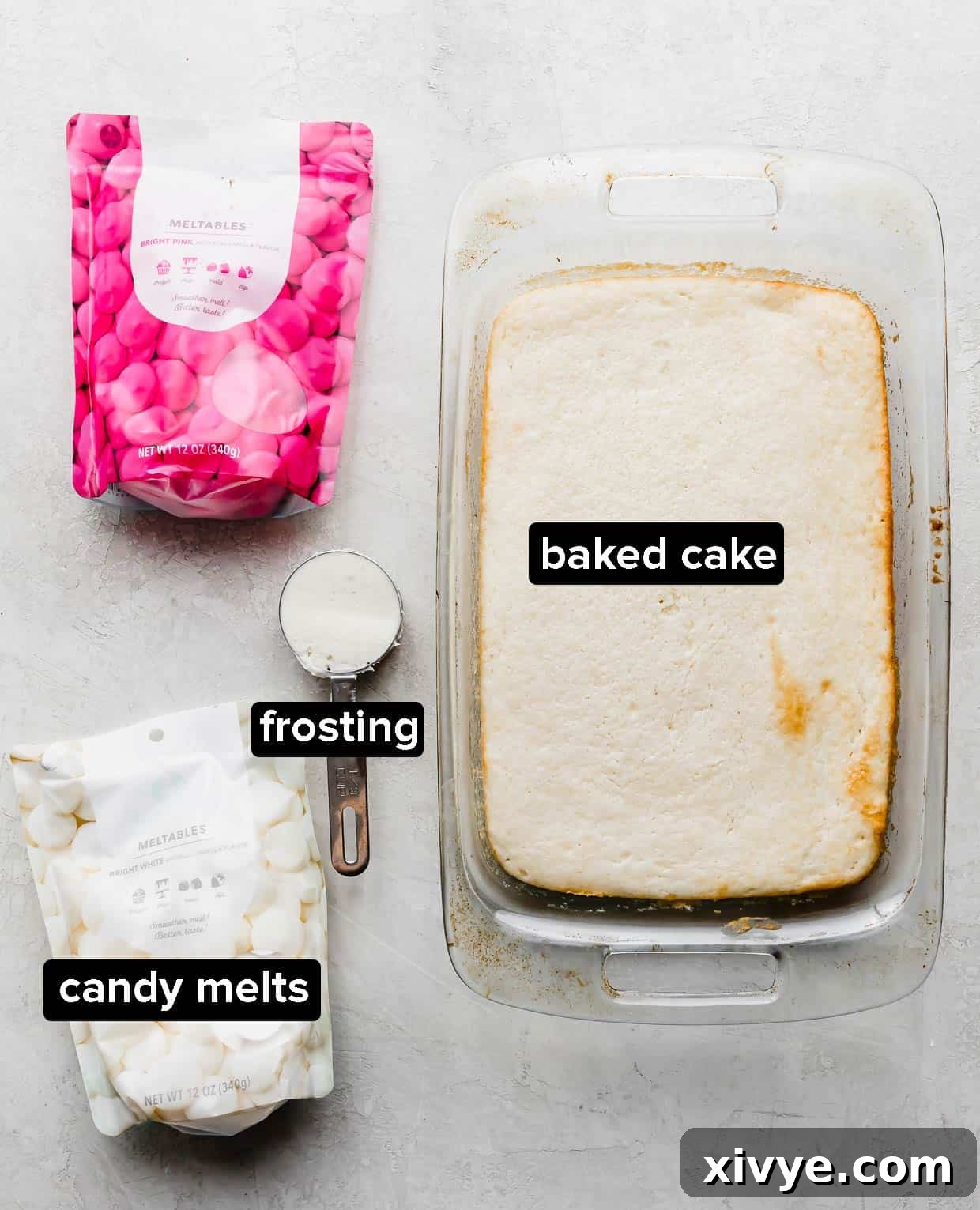 Delightful Cake Lollies 3 A collection of ingredients commonly used to make delicious cakesicles, neatly arranged on a gray background.