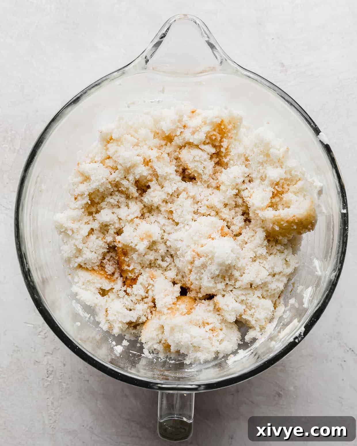 Delightful Cake Lollies 4 Freshly crumbled white cake fills a mixing bowl, ready for the next step in creating cakesicles.