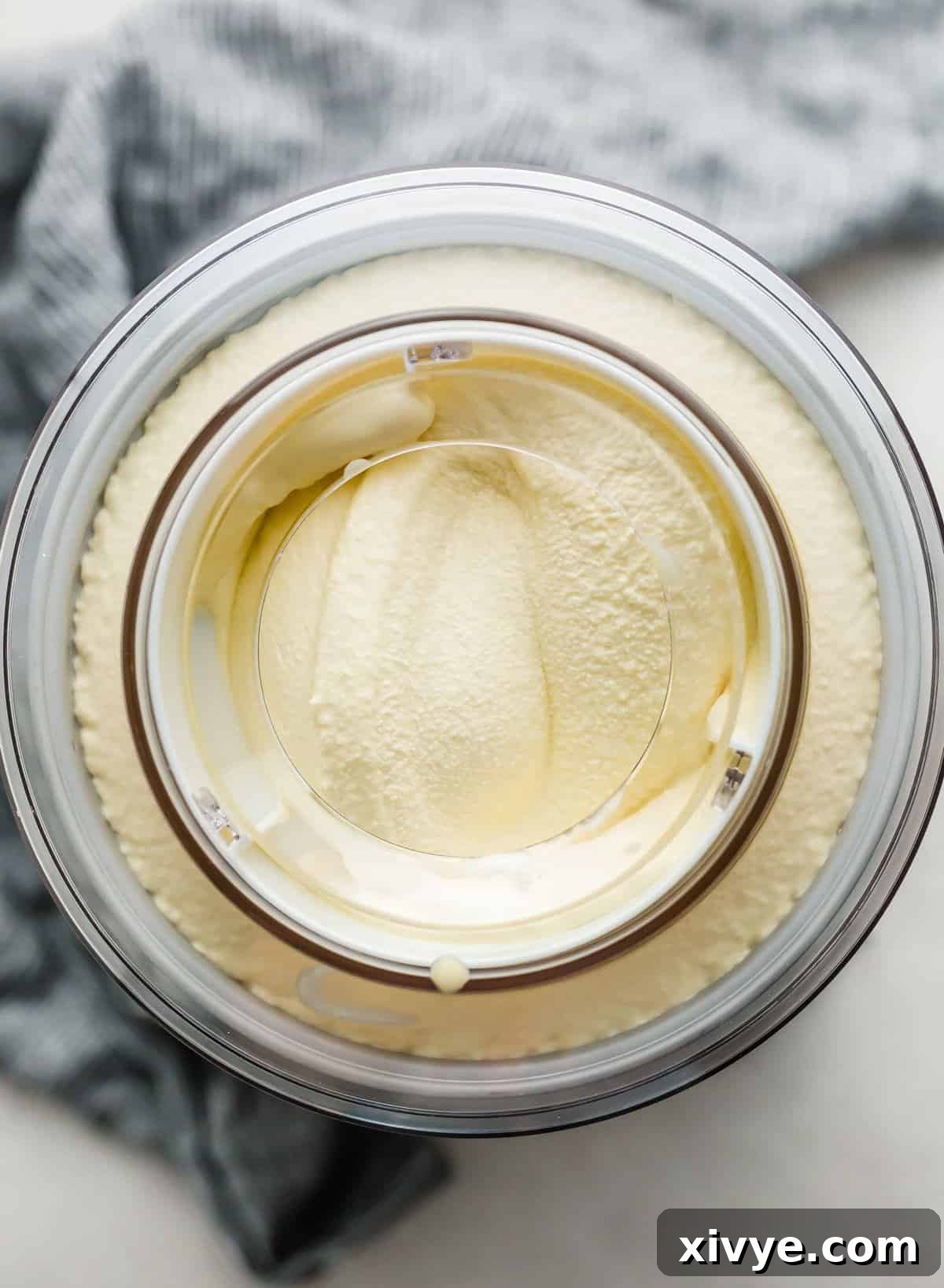 An ice cream maker churning Homemade Vanilla Ice Cream.