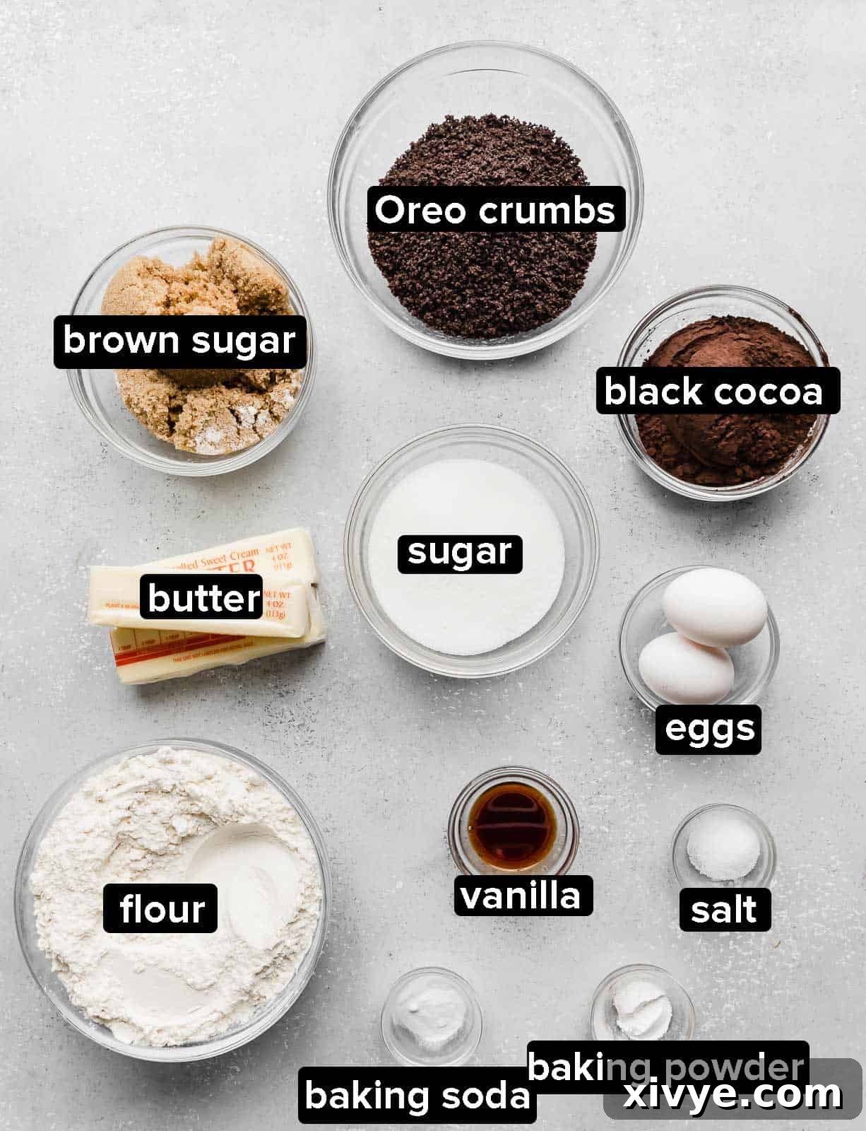 Giant Crumbl Style Chocolate Oreo Cookies 3 Chocolate Oreo Crumbl Cookie ingredients on a gray background.