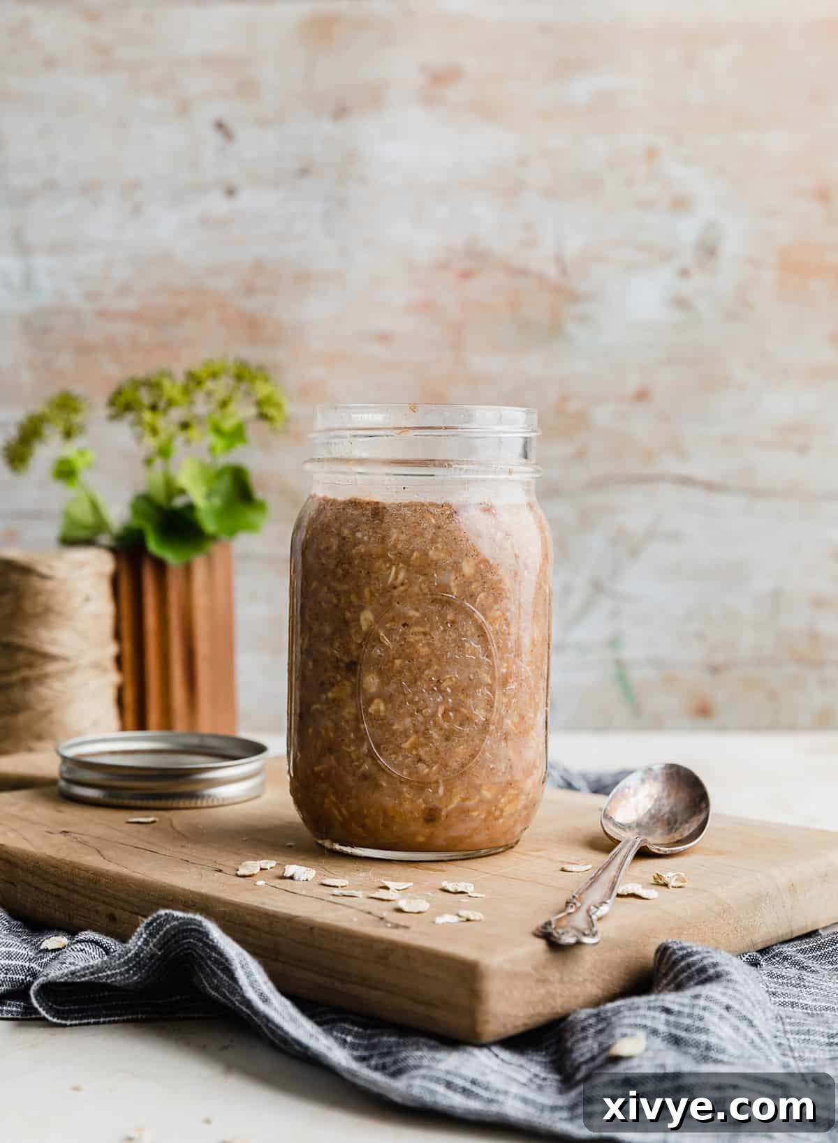 Powerhouse Protein Oats 6 High Protein Overnight Oats in a glass jar on a light brown cutting board.