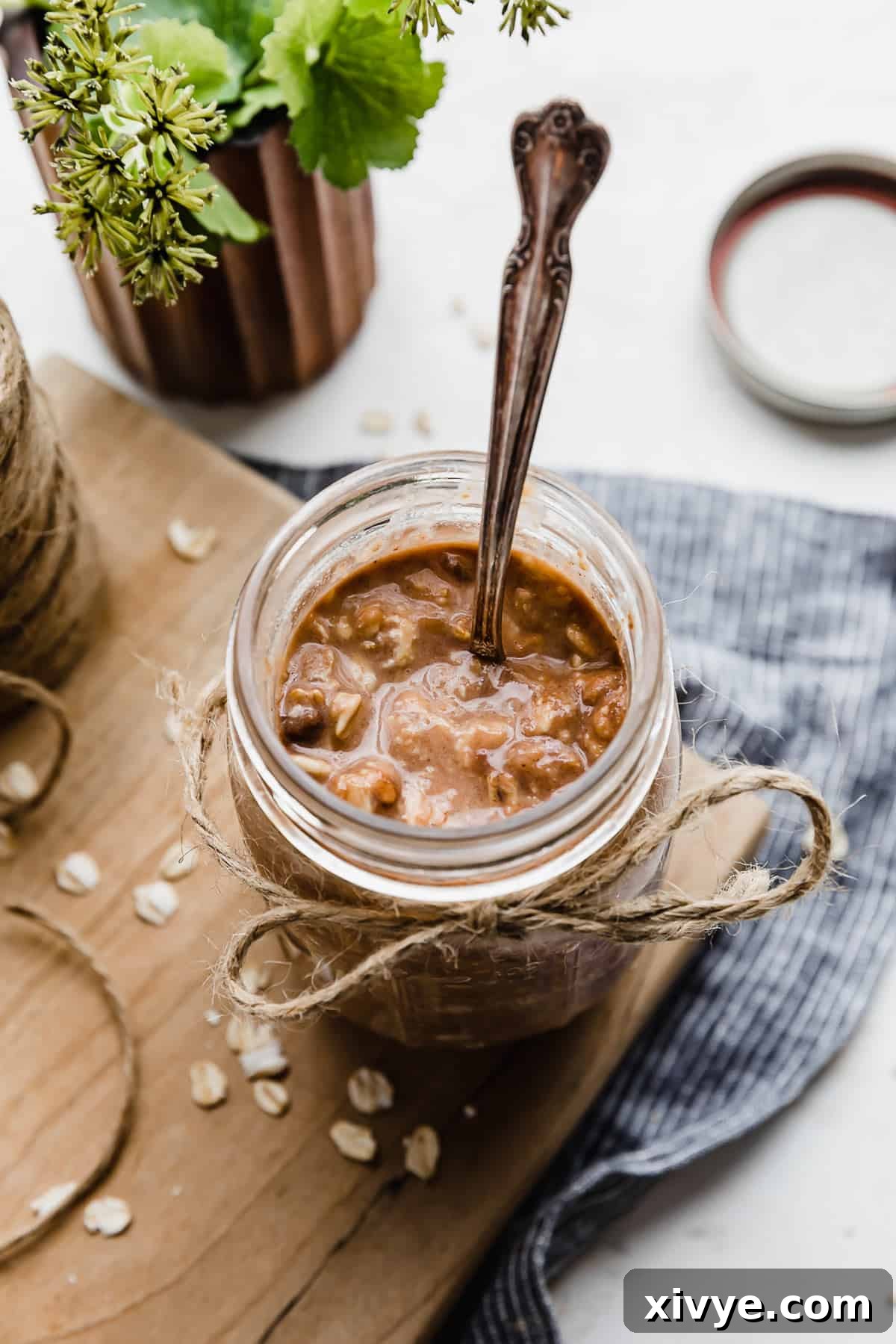 Powerhouse Protein Oats 7 High Protein Overnight Oats in a glass jar with twine tied in a bow around the top of the jar.